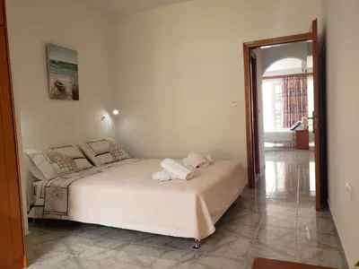 a bedroom with a bed with towels on it at Haraki Sunrise Apartments in Haraki