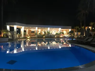 a swimming pool in front of a house at night at Pefkos Blue in Pefki Rhodes