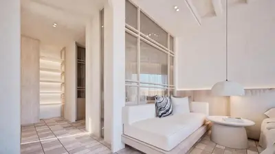a living room with a white couch and a toilet at Pefkos Blue in Pefki Rhodes