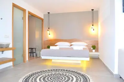 a bedroom with a bed and a rug at Lindos SeaSide Suite in Líndos