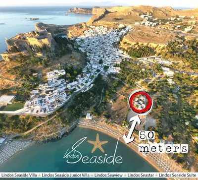 an aerial view of a harbor with a house and the ocean at Lindos SeaSide Suite in Líndos