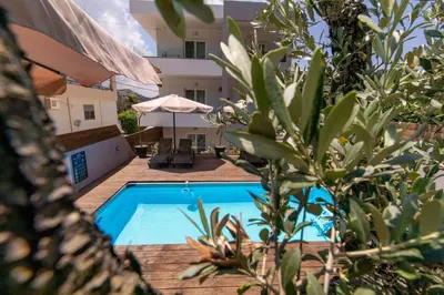 a swimming pool in front of a building at Akalli Studios in Ixia