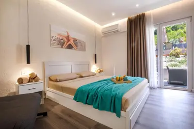 a bedroom with a bed with a table in it at Akalli Studios in Ixia
