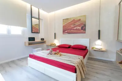 a bedroom with a large bed with red pillows at Akalli Studios in Ixia