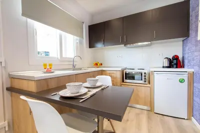 a kitchen with a table and chairs in a kitchen at Akalli Studios in Ixia
