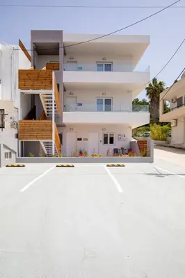 an empty parking lot in front of a building at Akalli Studios in Ixia