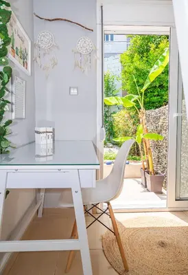 a white desk with a chair in front of a window at Monte Smith Hill in Rhodes Town