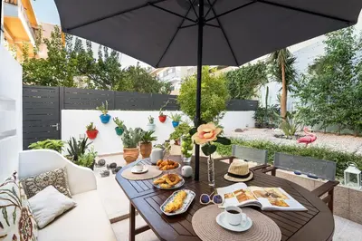 a table with food and an umbrella on a patio at Monte Smith Hill in Rhodes Town