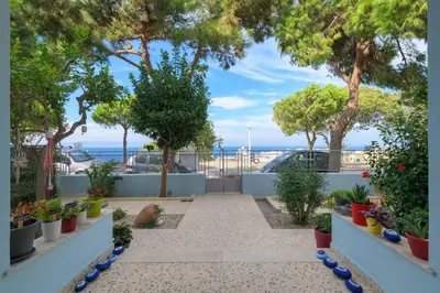 a garden with potted plants and a view of the ocean at Monte Smith Hill in Rhodes Town
