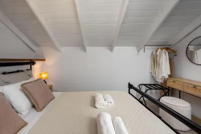 a bedroom with a bed with towels on it at Marias Sea House in Symi