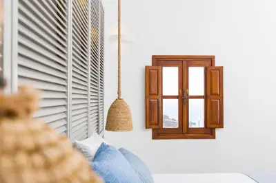 a room with a window and a swing at Lindos Del Mar Suites - Adults Only in Líndos