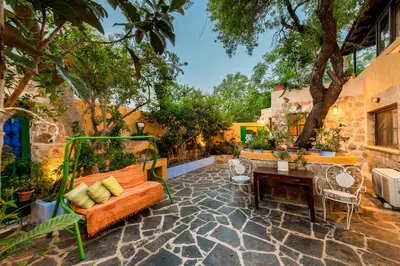 a patio with a couch and a table at Secret Garden - Old Town in Rhodes Town
