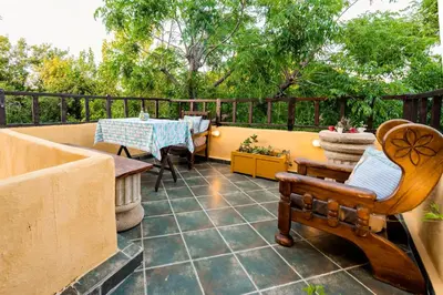 a patio with a table and a chair and a table at Secret Garden - Old Town in Rhodes Town