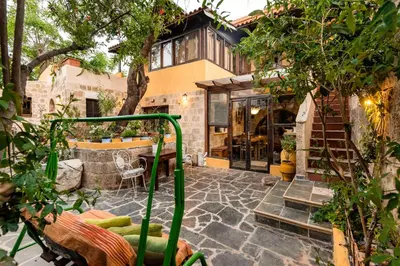 a house with a patio with a building at Secret Garden - Old Town in Rhodes Town