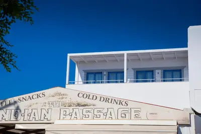a building with a sign that reads cold drinks and old drums at Lindos Portes Suites - Adults Only in Líndos