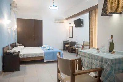 a hotel room with a bed and two tables at Antonios Hotel in Faliraki