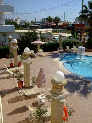 a resort with a swimming pool and chairs next to a swimming pool at Antonios Hotel in Faliraki