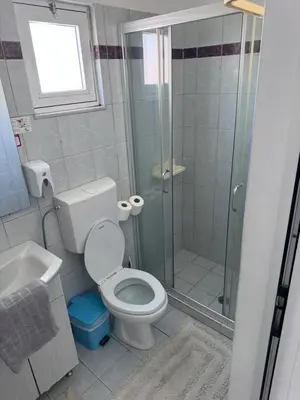 a bathroom with a shower and a toilet and a sink at SunnySun Studios in Faliraki