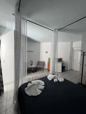 a bedroom with a bed with two towels on it at SunnySun Studios in Faliraki