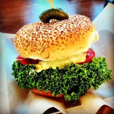 a bagel sandwich with a pickle on top of it at Tsambikos Apts in Faliraki