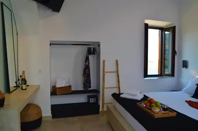 a bedroom with a bed with a tray of fruit on it at Lindos Aktaia Villa in Líndos