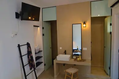 a bathroom with a sink and a mirror at Lindos Aktaia Villa in Líndos
