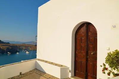 a door on a building with a view of the water at Lindos Aktaia Villa in Líndos