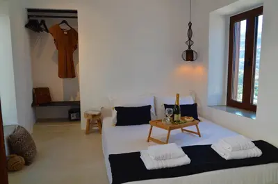 a room with a bed and a table in it at Lindos Aktaia Villa in Líndos