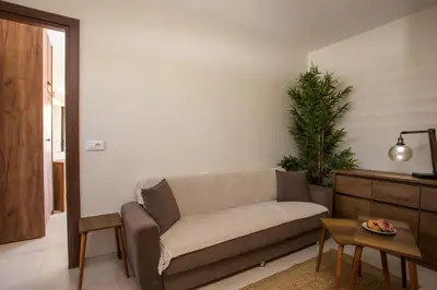 a living room with a couch and a table at Casa Lyristis in Faliraki