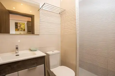 a bathroom with a toilet and a sink and a shower at Casa Lyristis in Faliraki