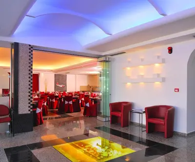 a banquet hall with red chairs and tables in a room at Kolymbia Bay Art Boutique Hotel - Adults Only in Kolimbia
