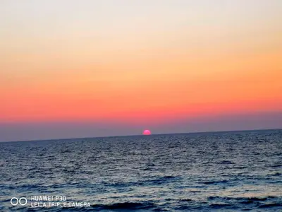 an orange and pink sunset over the ocean at Tsampika's Sea View Home in Archangelos