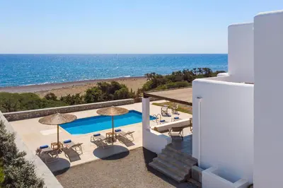 a villa with a swimming pool and a view of the ocean at Villa Corinna in Lachania
