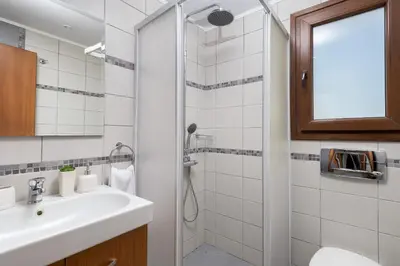 a bathroom with a sink and a shower at Villa Corinna in Lachania