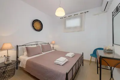 a bedroom with a bed with two towels on it at Villa Corinna in Lachania