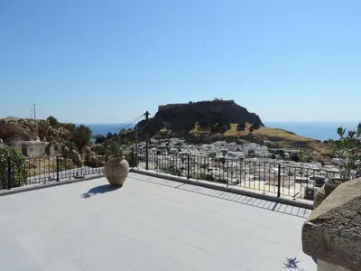 a balcony with a view of a city at Villa Anna Maria Lindos in Líndos
