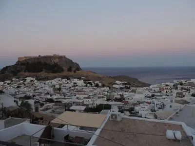 a view of a town with white buildings on a hill at Villa Anna Maria Lindos in Líndos