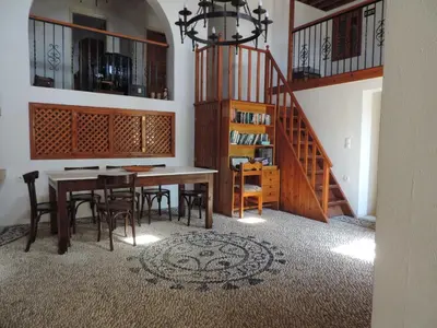 a dining room with a table and chairs and a staircase at Villa Anna Maria Lindos in Líndos