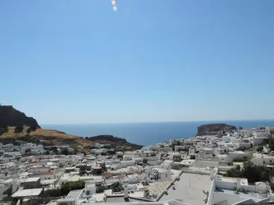 a view of a white city with the ocean in the background at Villa Anna Maria Lindos in Líndos