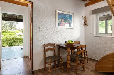 a dining room with a table and two chairs at Elefteria Apts & Suites in Kolimbia