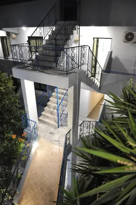 a spiral staircase in a building with blue railing at Maritime in Kremasti