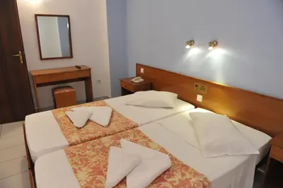 a hotel room with a bed with two pillows on it at Maritime in Kremasti