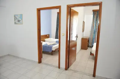 a room with a bedroom with a bed and a mirror at Maritime in Kremasti