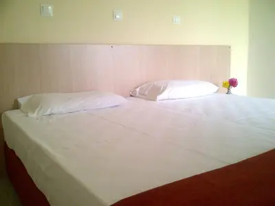 a large white bed with two pillows on it at Thalassa Studios in Faliraki