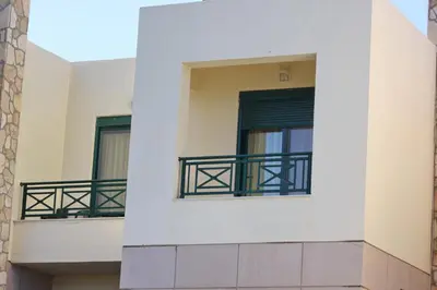 a building with two windows and a balcony at Athina in Kiotari