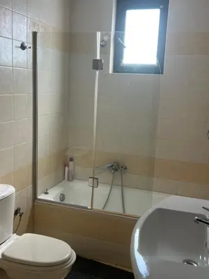 a bathroom with a tub and a toilet and a sink at Athina in Kiotari