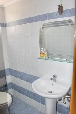 a bathroom with a sink and a toilet at Athina in Kiotari