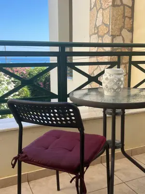 a table and a chair with a bowl on a table at Athina in Kiotari
