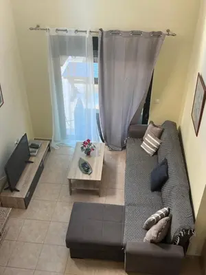 a living room with a couch and a table at Athina in Kiotari