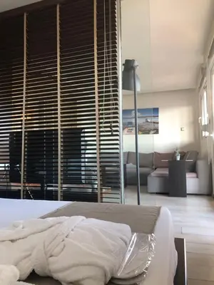 a bedroom with a bed and a living room with a couch at MV83 new marina in Rhodes Town